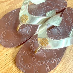 Tory Burch gold patent flip flops